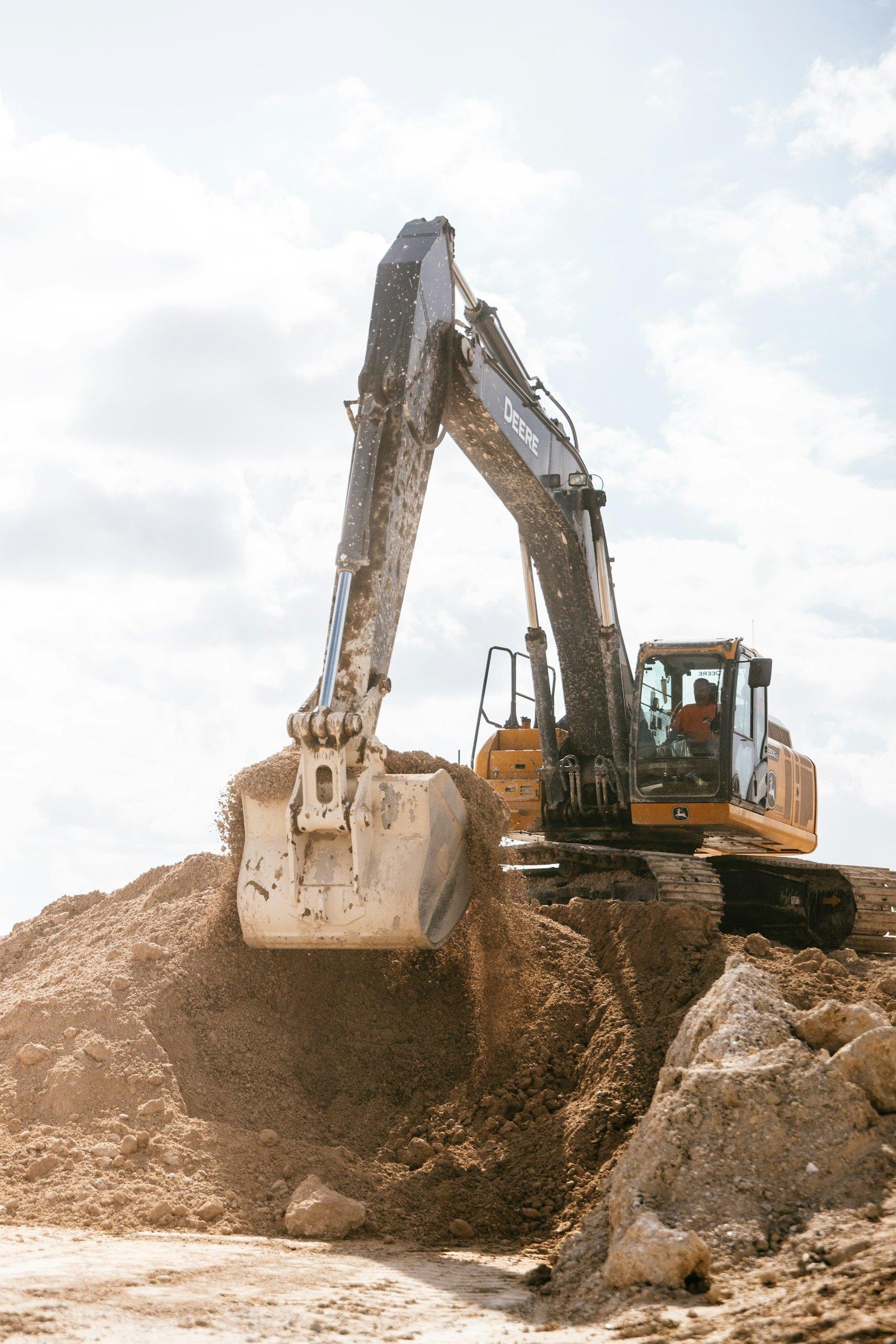 Excavator preparing a raw plot for construction in Multan